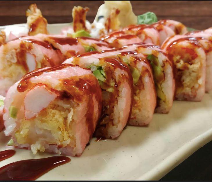 Joyo Roll · Shrimp tempura, lobster salad, eel and avocado wrapped with pink seaweed with eel sauce.