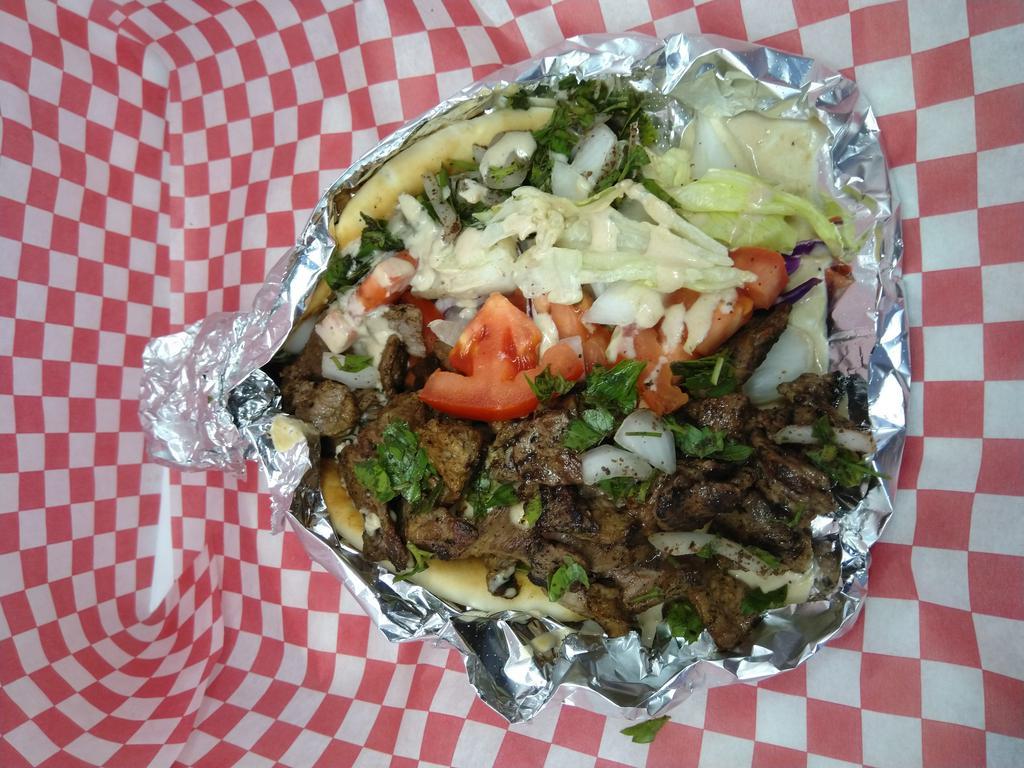 Beef Shawarma (Gyro ) · Beef Shawarma (Gyro)
 Thinly slidced grilled beef served  on Pita bread with parcly ,onion,tomato,lettes and Tahiti souce ;extra 1$ Yougard and cucumber mix