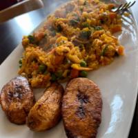 Arroz con Pollo · Seasoned yellow rice mixed with shredded chicken, peas, carrots, and Colombian spices. Serve...