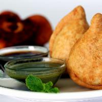 2 Pieces Vegetable Samosa · A fried pastry with a savory potato filling.