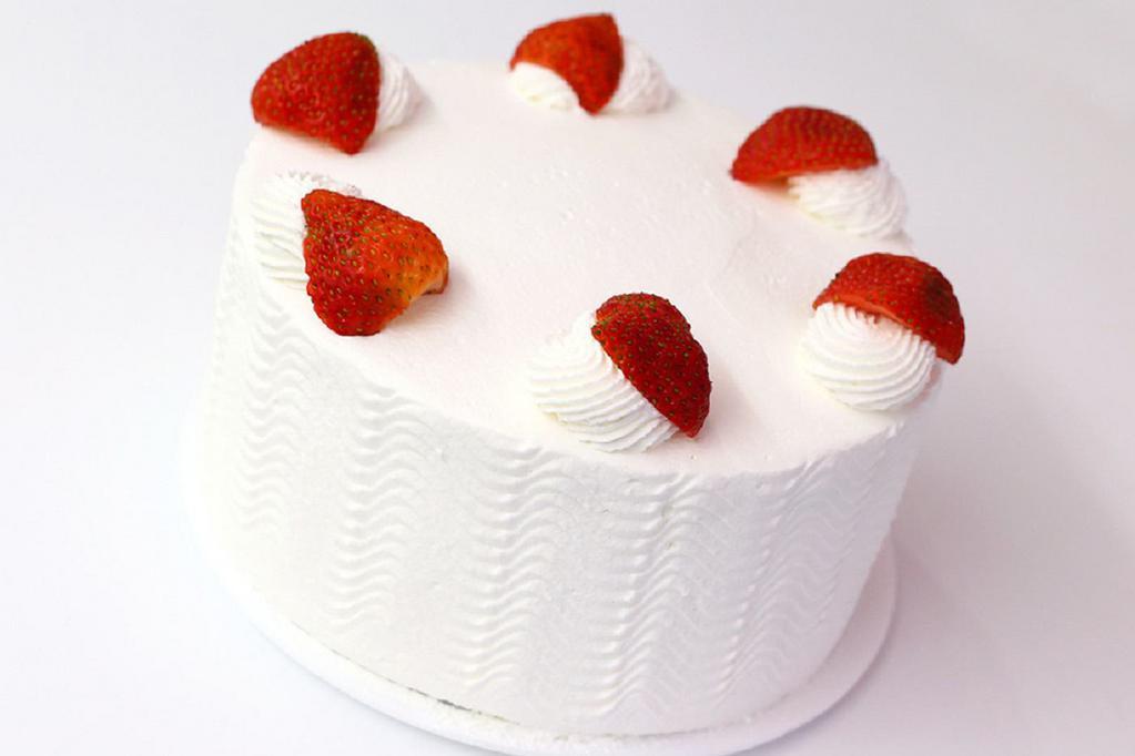 Strawberry Shortcake · Yellow cake with fresh strawberry filling and whipped cream frosting.