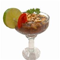 Ceviche de Conchas Negras · Mussels marinated in lime juice and onions. Served with Peruvian corn. 