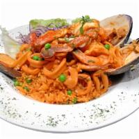 Arroz Con Mariscos · Seafood mixed with rice, made at Peruvian style.