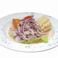 Ceviche de Pescado · Diced Fish Marinated in Lime Juice and Onions, Served with Peruvian Corn and Sweet Potato.