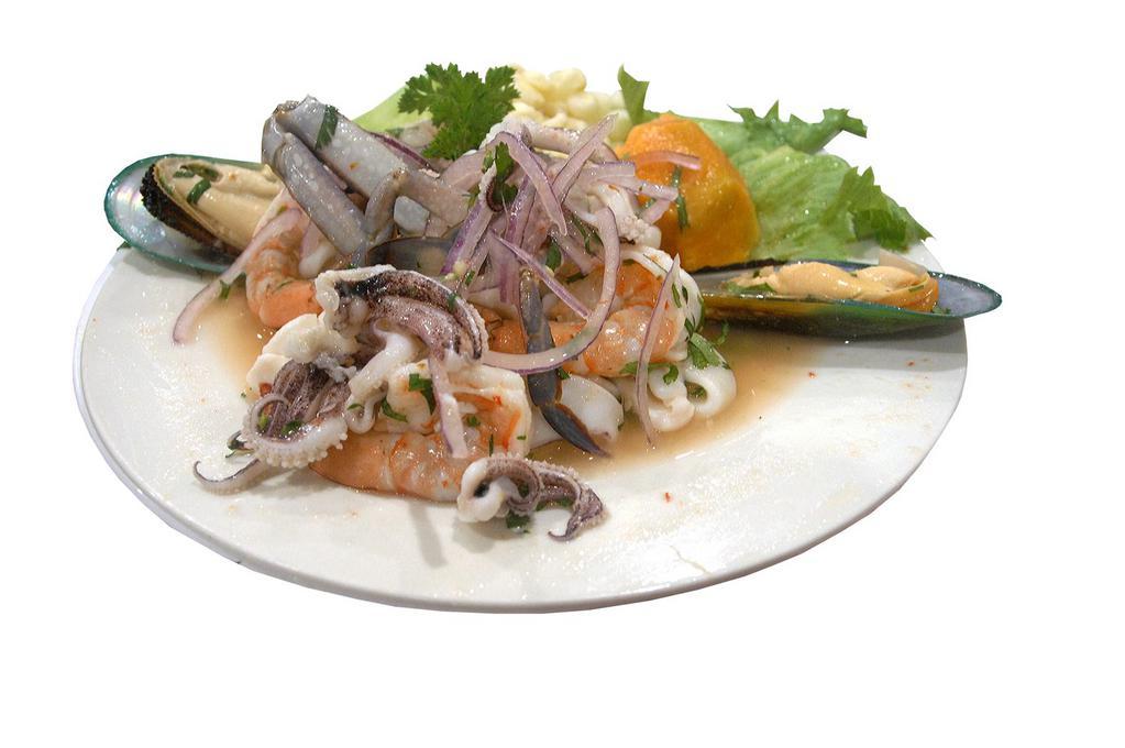 Ceviche de Mariscos · Seafood marinated in lemon juice served with onions, peruvian corn, and sweet potato.