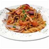 Tallarin Saltado De Carne · Linguini sauteed with strips of beef with onions and tomatoes.