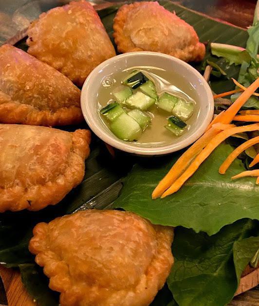 Curry Puff · Curry flavored potato and onion in crispy puff pastry served with ​sweet cucumber relish.