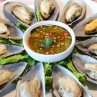 Steam Mussel · Steam mussel, lemongrass and basil leaves with seafood sauce.