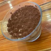 Tiramisu · Sponge cake soaked in espresso, topped with mascarpone cream and dusted wi itth cocoa powder.