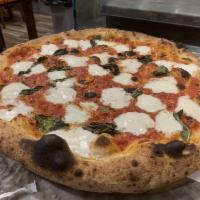 Margherita Pizza · Homemade mozzarella, basil, tomato sauce, extra virgin olive oil and Parmesan cheese.