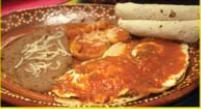 Huevos Rancheros · 2 huevos estrellados, sobre dos tortillas, fritas acompanados con salsa cocida, frijoles, pa...