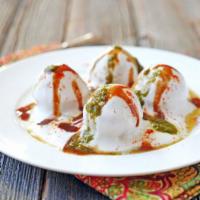 Dahi Vada (Contains Yogurt) · Soft vada made with lentil soaked in sweet yogurt, topped with sweet and spicy chutney.