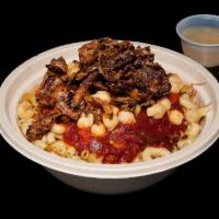 Koshari · Rice, lentils, elbow pasta, chickpeas, tomato sauce and topped with fried onions.