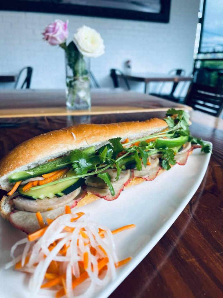 Banh Mi · Toasted baguette with butter spread along with choice of protein, cucumber, cilantro, jalapenos, pickled carrots, pickled radish and house BBQ sauce inside.