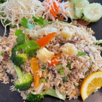 Pineapple Island Fried Rice  ·  Golden fried rice with sliced steaks, eggs, broccoli, bell peppers, pineapple chunks, and g...