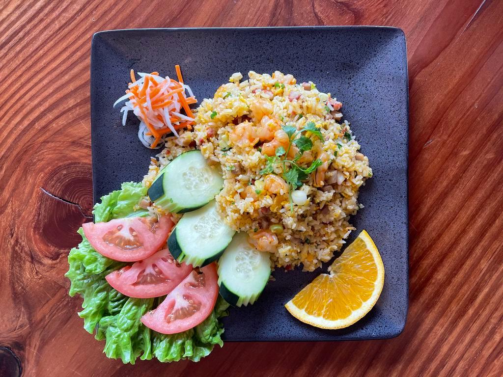 Shrimp Pork Fried Rice ·  Golden fried rice with pieces of shrimp, pork, eggs, and green onion served with pickled carrots, pickled radishes, cucumber, tomato.