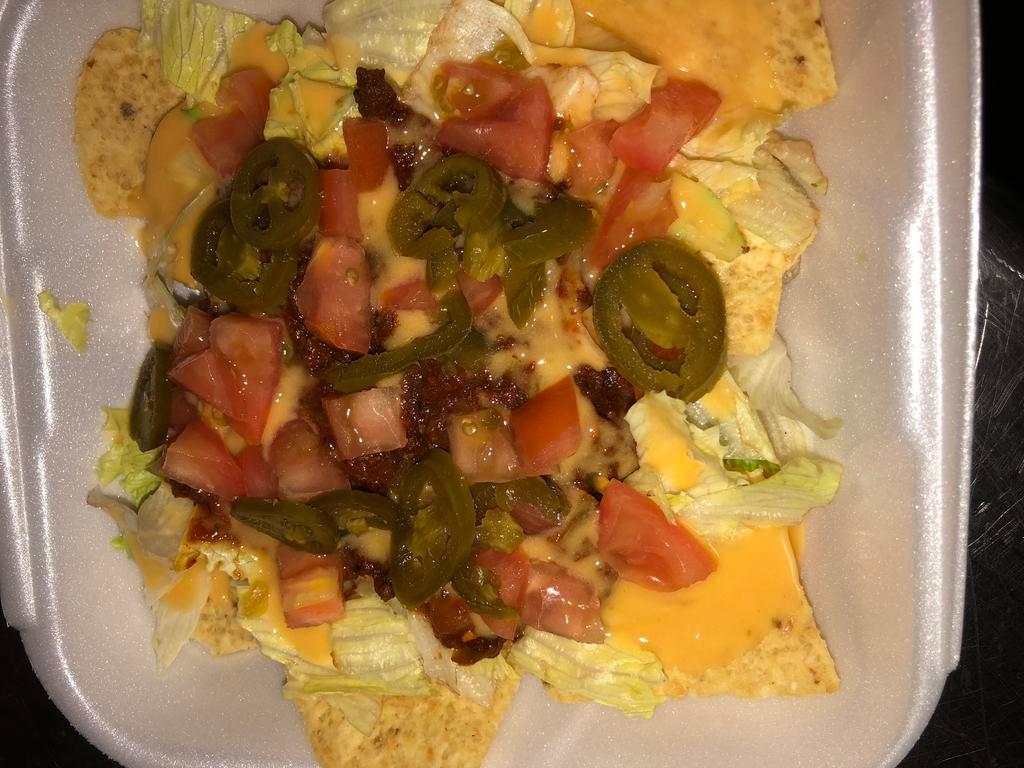 Taco Salad · A bed of tortilla chips with seasoned ground beef and cheese. Served with lettuce, tomatoes, and jalepenos.