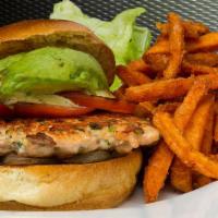 Salmon Burger · Fresh ground salmon, avocado, grilled tomato, caramelized onions and cilantro aioli.