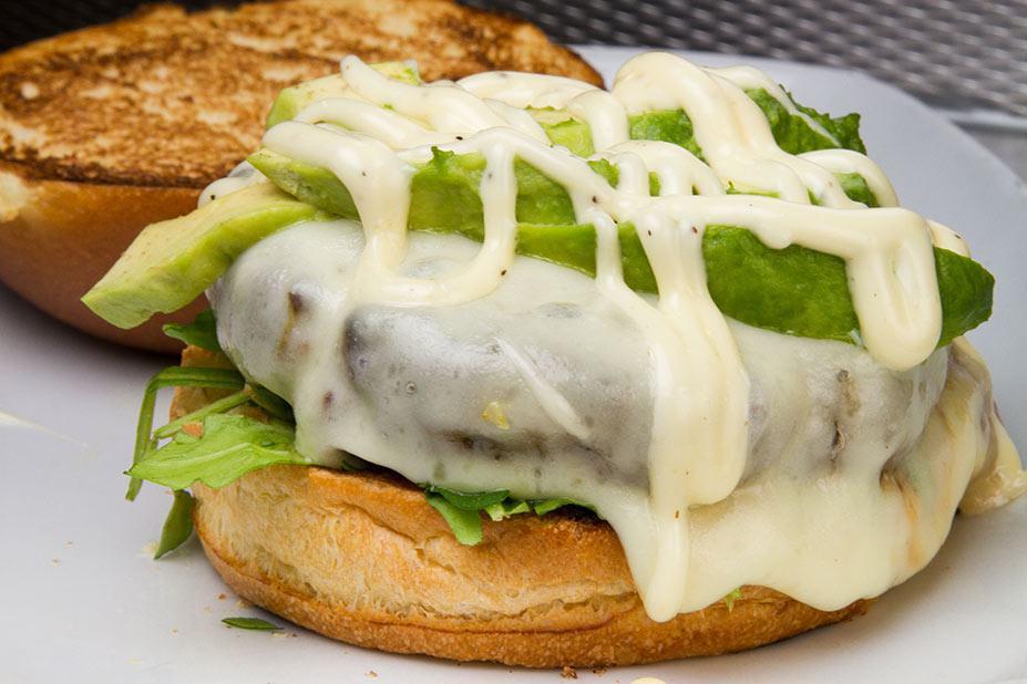 Signature Burger · Truffle mayonnaise, baby arugula topped with avocado and provolone cheese. Served with coleslaw and pickle. Make it deluxe for an additional charge.