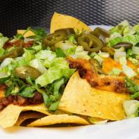 Fiesta Nachos · Tortilla chips, housemade chili, jalapeno peppers, cheddar cheese, diced lettuce and tomatoes.