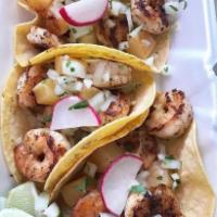 1 Shrimp Taco · Large shrimp, seasoned and lightly buttered. topped with onion/cilantro mix, and a lime for ...