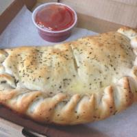 Mozzarella Calzone · Stuffed with mozzarella, ricotta and your choice of toppings. Served with pizza sauce on the...