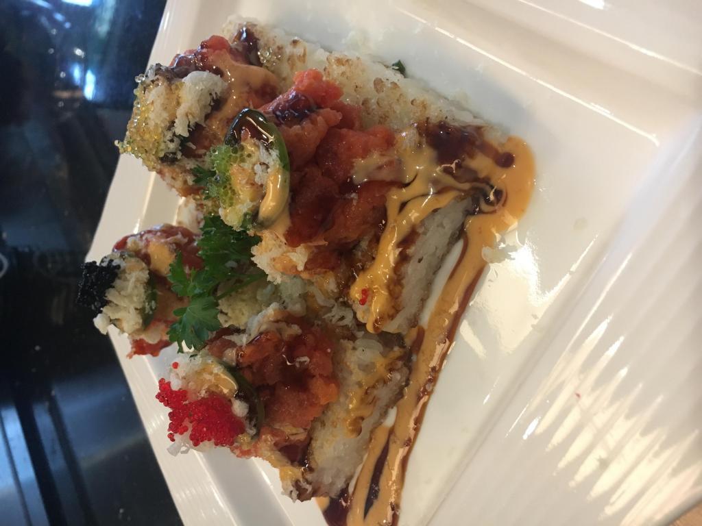 Spicy Tuna Biscuit · Spicy tuna and jalapenos on top of crispy rice with tobiko and wasabi mayo and eel sauce.