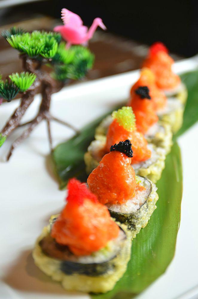 Volcano Roll · Deep fried spicy tuna and avocado, topped with spicy salmon and tobiko.