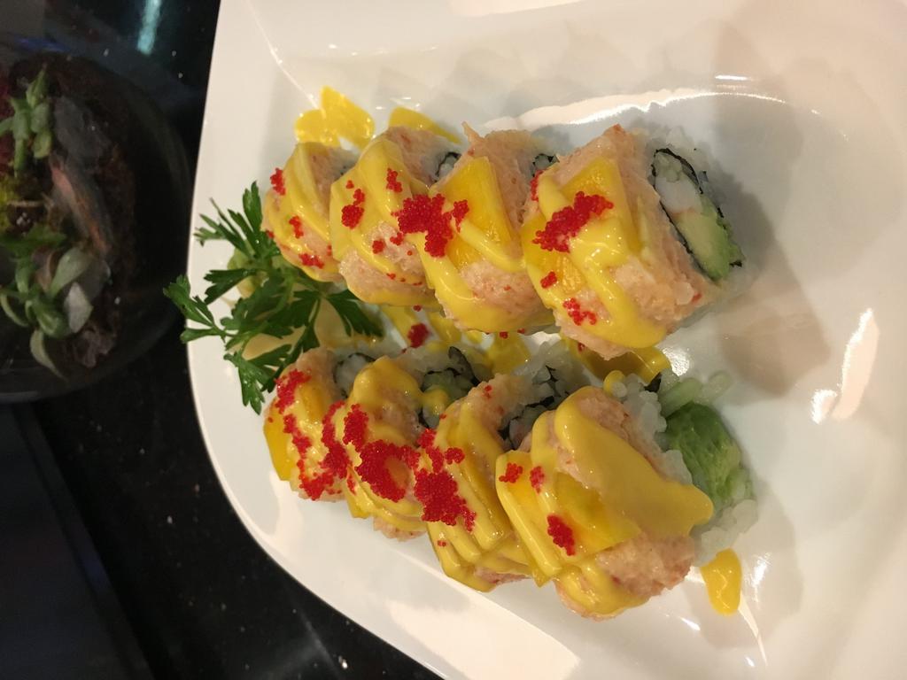 Lobster Rock'N Roll · Shrimp, avocado, and cucumber inside, topped with lobster salad, mango and tobiko.