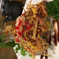 Ocean 13 Roll · Shrimp tempura and mango inside, spicy tuna and crispy crab meat flake on top.
