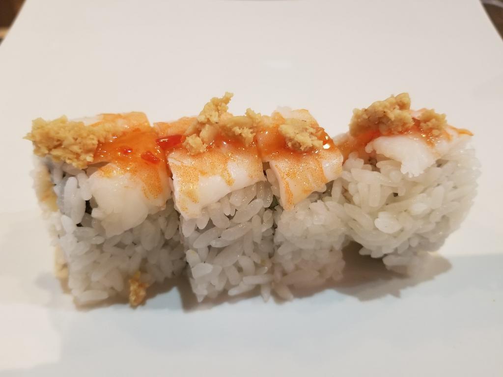 Ichi Roll  · 4 pieces. Crab salad, cucumber, topped with ebi, peanuts, and sweet chili sauce.