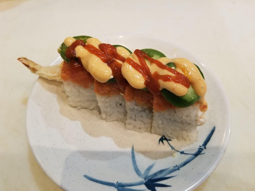 Red Dragon Roll  · 4 pieces. Crab salad, shrimp tempura, topped with spicy tuna, jalapeno slices, spicy mayo, and Sriracha. Raw.