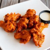 Buffalo Wings · A full lb. of crispy wings with your choice of Buffalo sauce, garlic Parmesan, gochujang, ho...