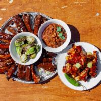 Ultimate Platter · Two racks of smoked baby back ribs. 10 wings. Brussel sprouts. Two servings of savory chili.