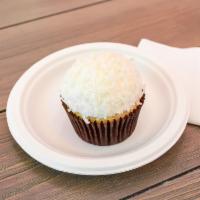 Coconut Single · Coconut cake with vanilla buttercream frosting and topped with shaved coconut.