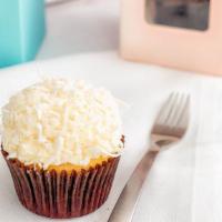Coconut Dozen · Coconut cake with vanilla buttercream frosting and topped with shaved coconut.