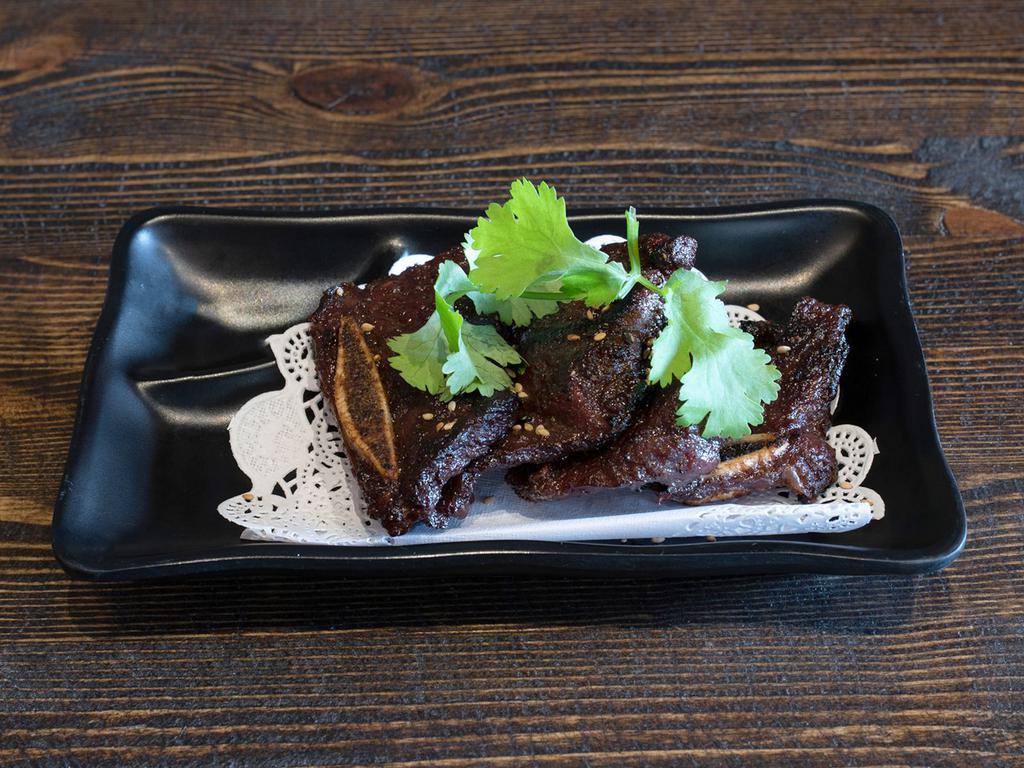 Korean Kalbi Beef · Marinated short rib in spicy Korean sauce. Served with miso soup and white rice. Hot and spicy.