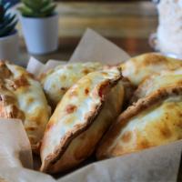 4 Cheese Empanada · A delicious blend of swiss, muenster, parmesan and feta cheese