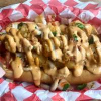 Breakfast Dog · Made with scrambled eggs, grilled ham, tater tots, and topped with pico de gallo and a chipo...