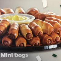Mini pretzel dog · Our delicious all beef hot dog wrapped in pretzel dough  in bite size.  6 mini dogs per orde...