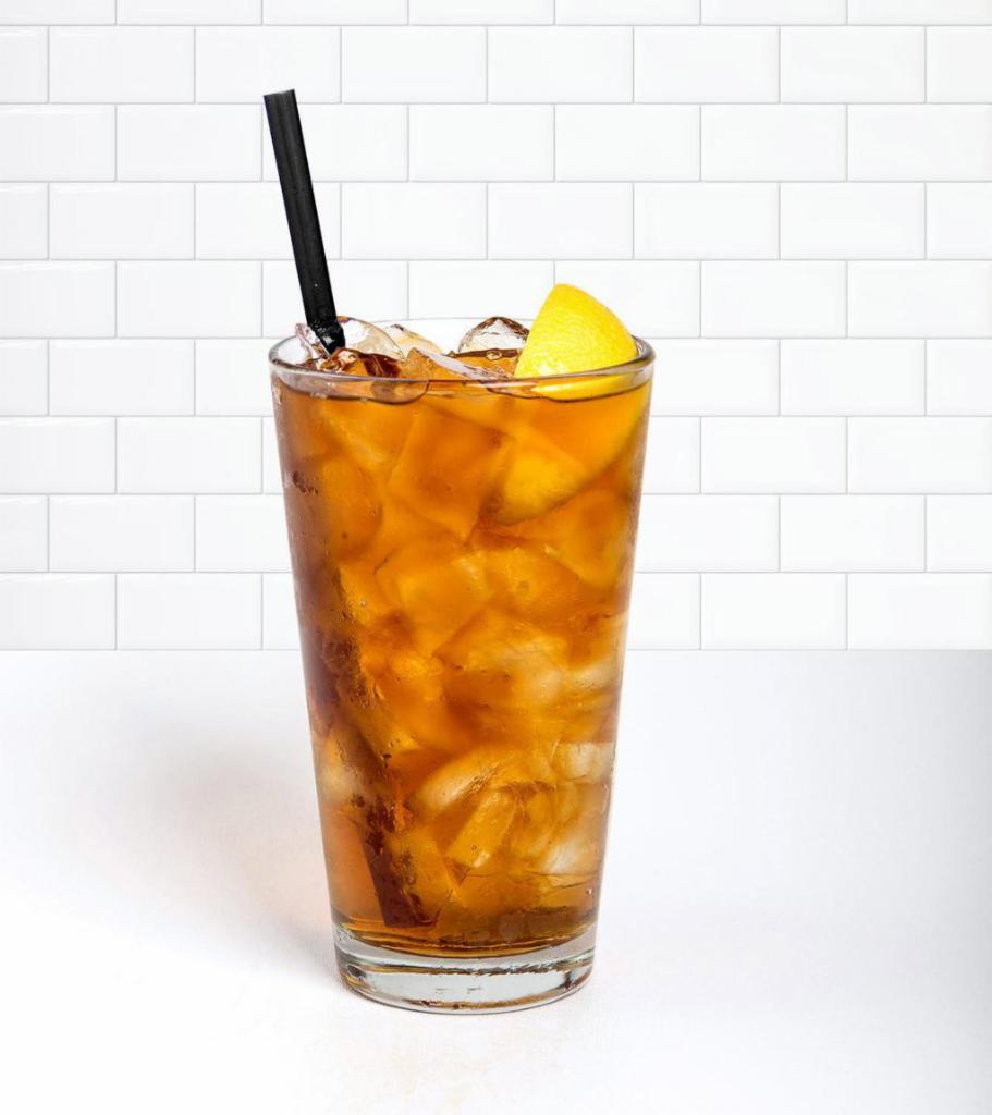 Iced tea with a slice of Lemon · Refreshing ice cold drink.