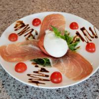 Burrata Cheese · Over speck and cherry tomatoes with a balsamic glaze.