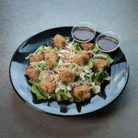 Asian Salad · Crisp greens topped with Rex's Original, Grilled or Jalapeño chicken, slivered almonds, shre...