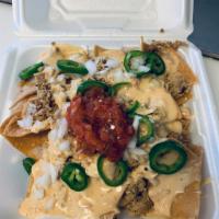 Pit-stop Nachos · Choice of meat, queso, jalapeños, onions and salsa loaded on a bed of fresh corn tortilla ch...