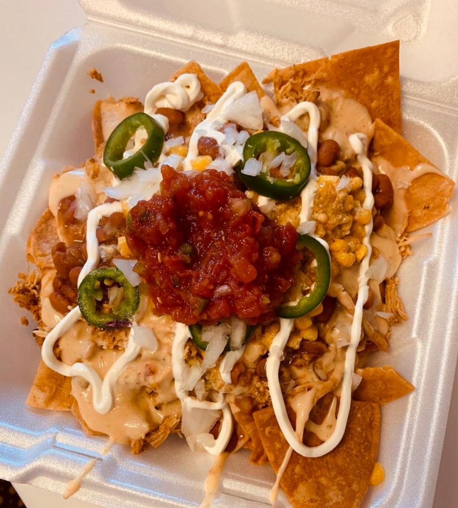 Racer Nachos · Choice of meat, queso, borracho beans, Mexican corn, sour cream, jalapeños, onions and salsa loaded on a bed of fresh corn tortilla chips.