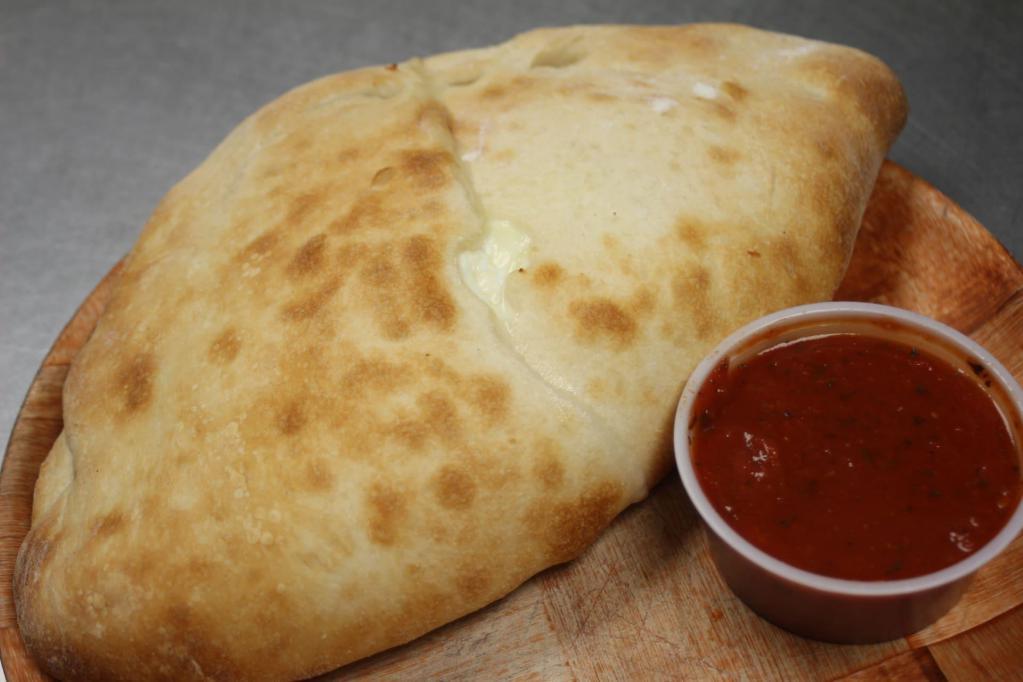 Ricotta Calzone · Stuffed with ricotta and mozzarella. Add toppings for an additional charge.