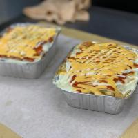 Yaroas · Mashed sweet plantain or French fries -- topped with shredded meat, cheese, and drizzled wit...