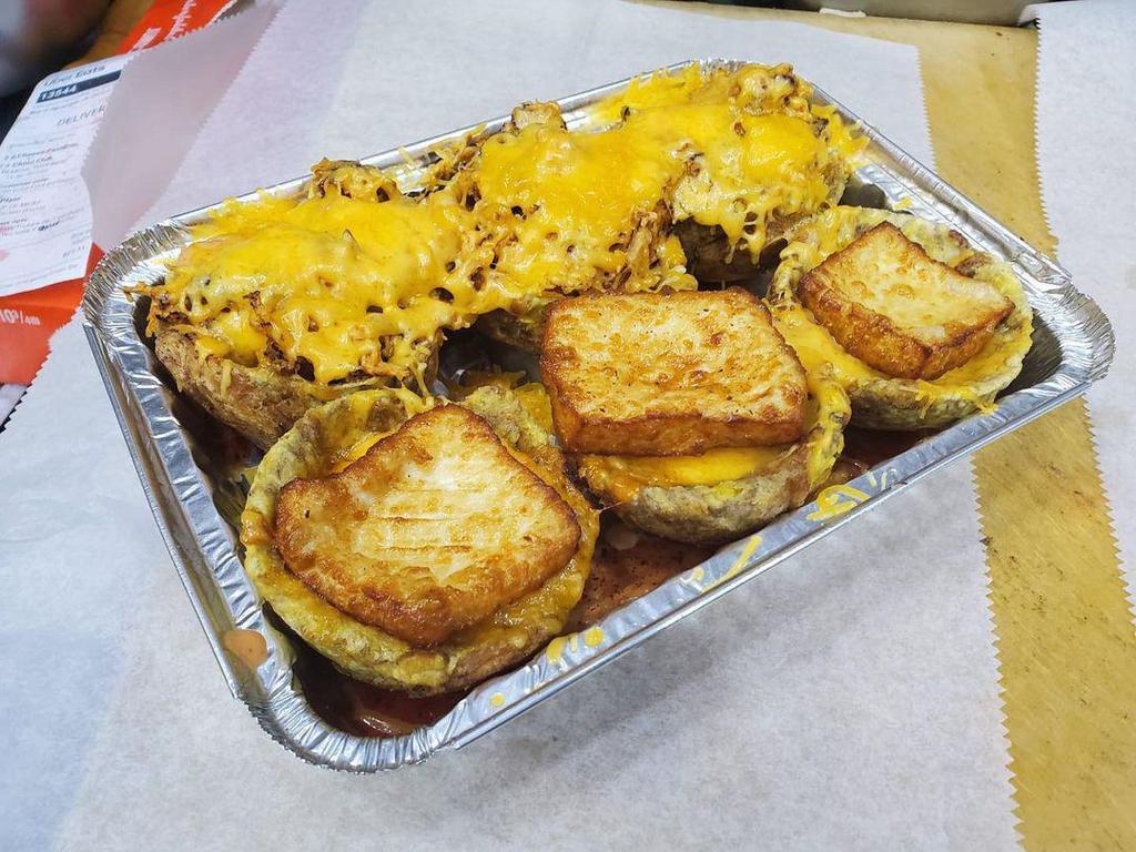 Mofonguito · Fried plantain cups topped with your choice of meat, cheese, and drizzled with with house made salsa rosa.