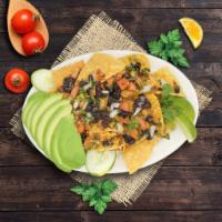 Super Nacho grilled steak · Black Beans, guacamole, sour cream, pico de gallo and cheese.