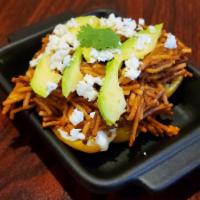 Fideos Secos · Dried noodles served on a bell-pepper, with a bed of cream cheese, cilantro, panela, and a s...